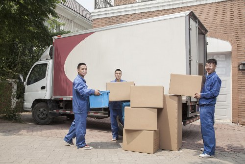 Moving team loading furniture with safety equipment in Wimbledon