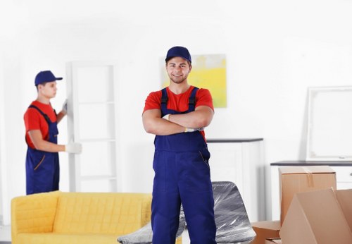 Furniture pick-up service removing a sofa in Wimbledon